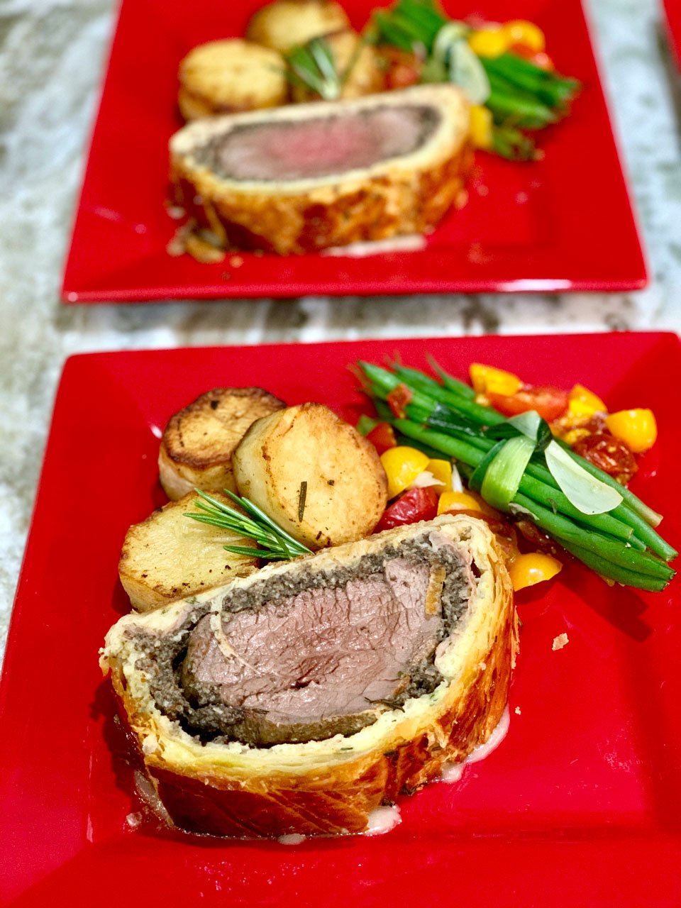 Beef Wellington served with fondant potatoes and green bean bundles