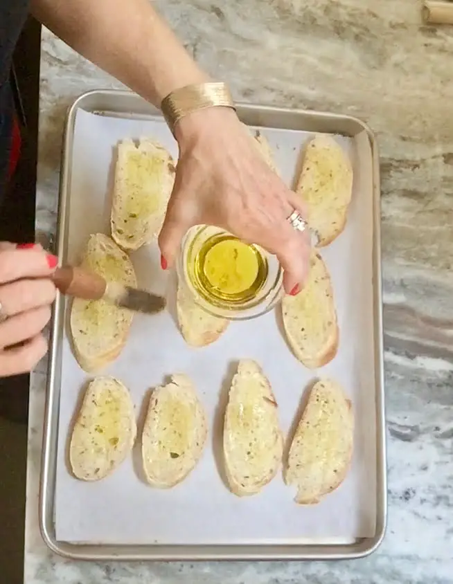 brushing bread with olive oil