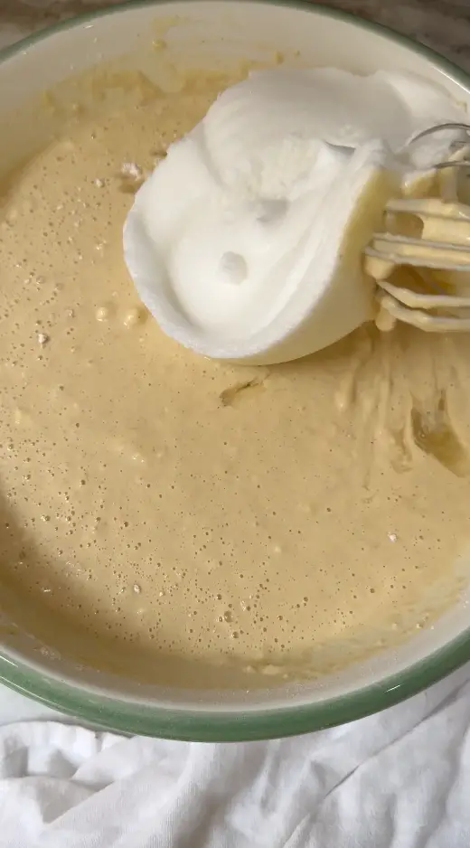 Whisking The Egg Whites Into The Creamy Batter