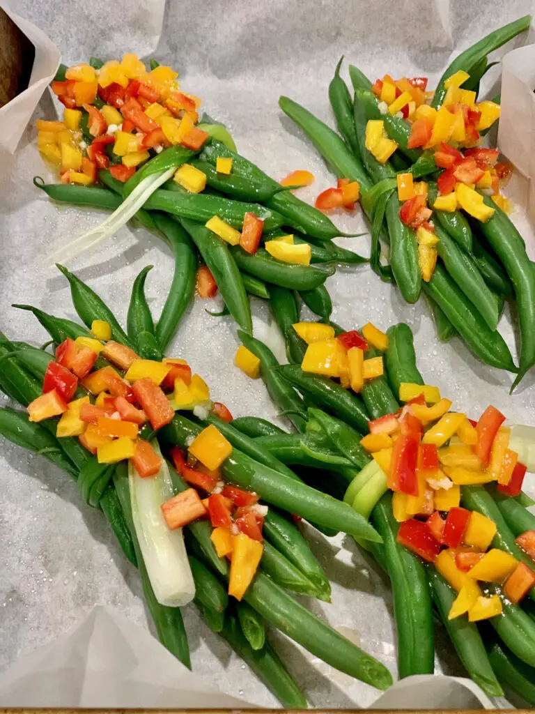 Green Bean Bundles Tied With Leeks And Topped With Bell Peppers