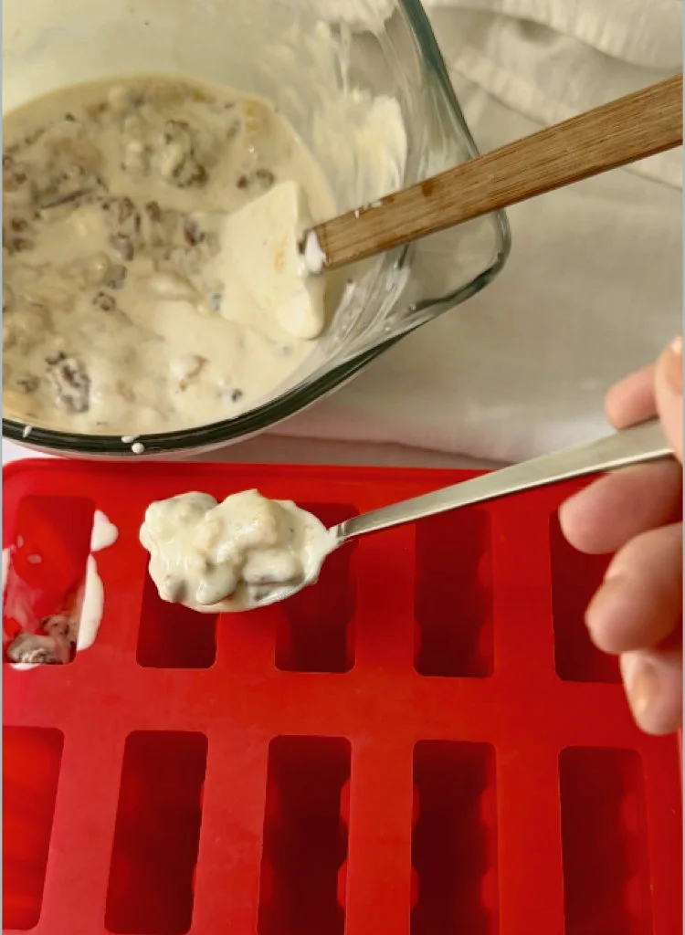Filling The Popsicle Molds With Creamy Peach Mixture