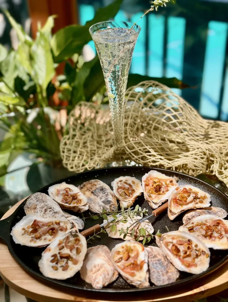 Roasted Oysters On The Half Shell With Champagne Sauce Prosciutto and Pistachios